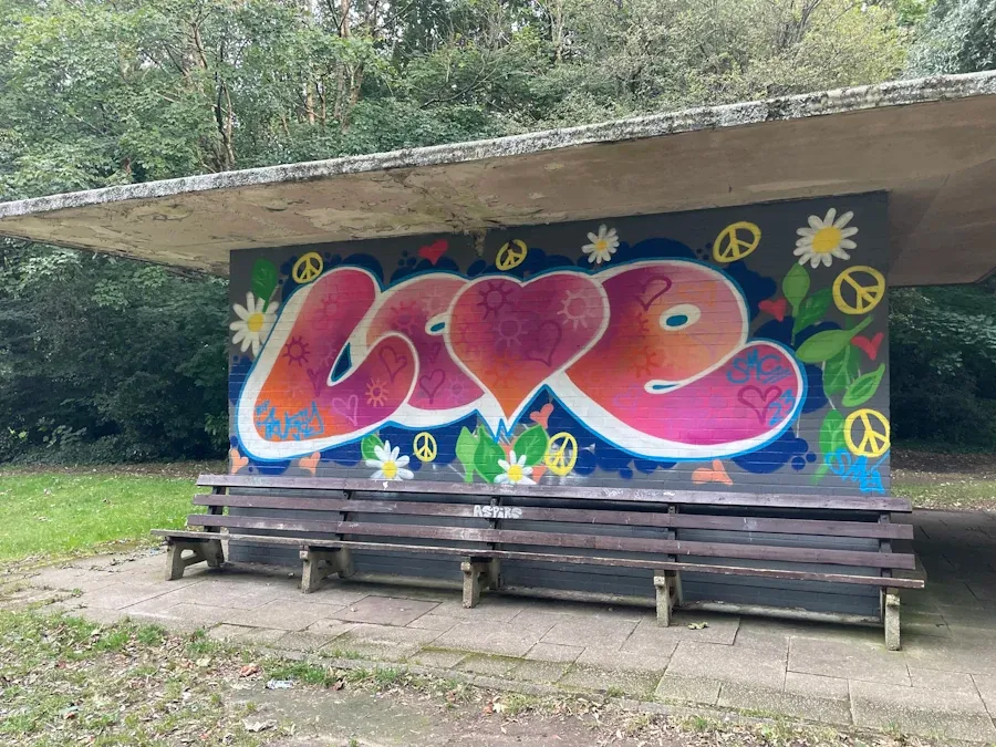 A mural of the word love on a utility box